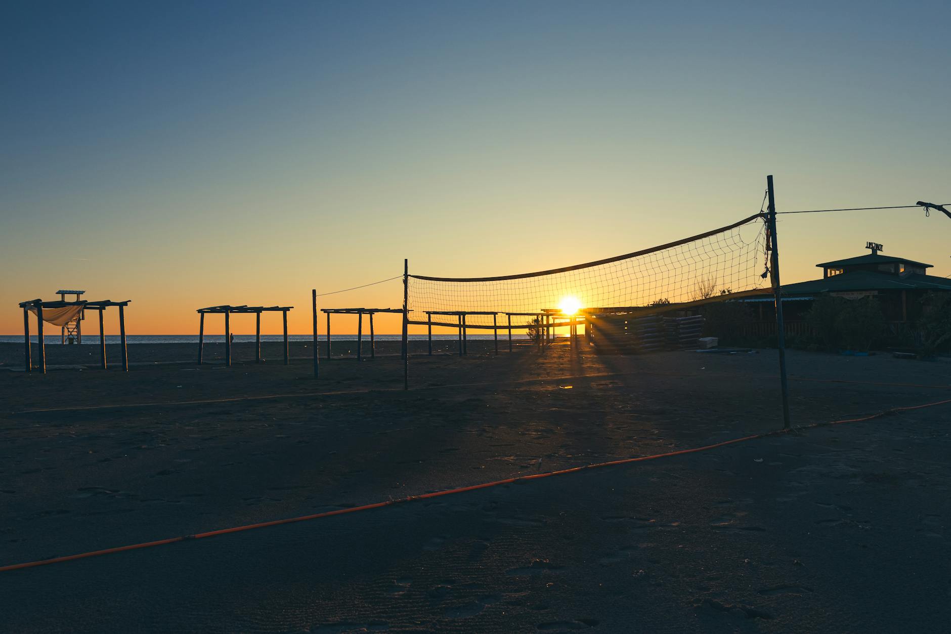 Boisko do siatkówki plażowej o zachodzie słońca nad morzem